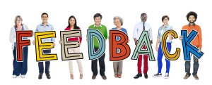 People Standing Holding Feedback Letter